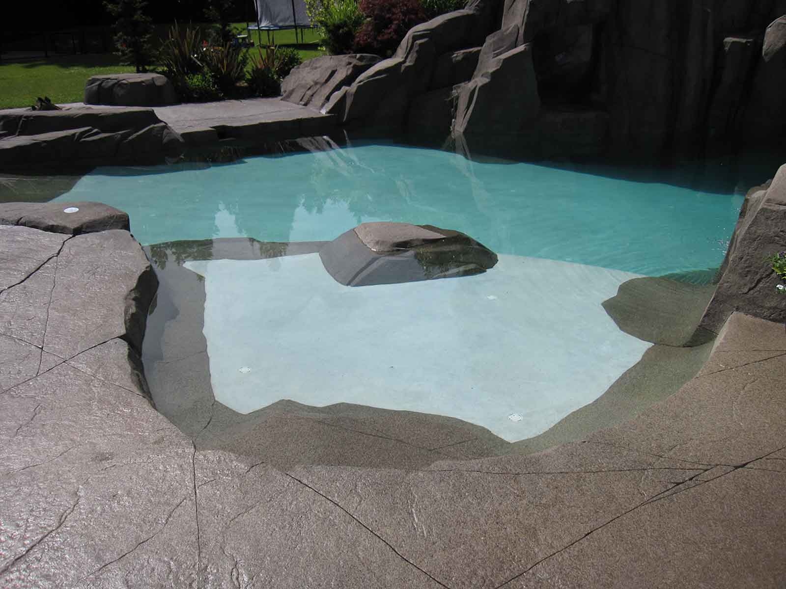 High strength concrete paving surrounding inground swimming pool